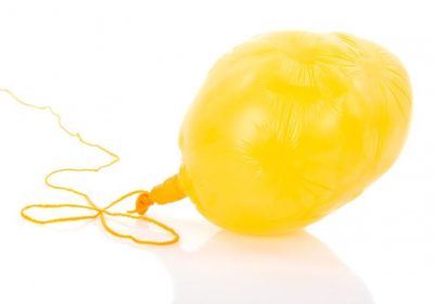 17745767 - deflated yellow balloon at a rope; isolated over white